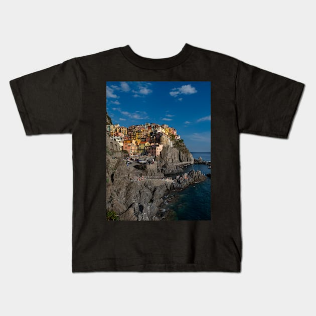 View on the cliff town of Manarola, one of the colorful Cinque Terre on the Italian west coast Kids T-Shirt by Dolfilms